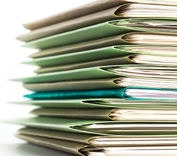 Some manilla files in a stack.